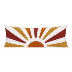 an orange and white pillow with the sun on it