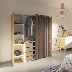 an open closet with clothes hanging on the door and shelves in front of it, next to a bed