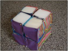 the cubes are stacked on top of each other in different colors and sizes,