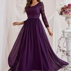 a woman in a long purple dress with sheer sleeves and lace on the neckline