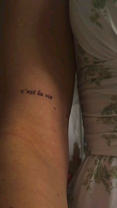 the back of a woman's arm with an inscription on it