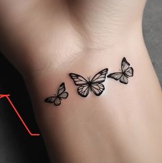 three butterflies tattoo on the left side of the right arm, and an arrow in the background