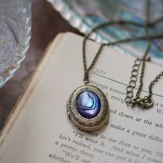 Shell Oval Locket in Pink, Blue, Purple or Yellow - Etsy Antique Silver Vintage Locket Necklace Gift, Bronze Oval Locket Necklace Gift, Blue Antique Finish Jewelry For Gift, Blue Antique Finish Jewelry Gift, Vintage Nickel-free Locket Necklace For Keepsake, Vintage Blue Keepsake Jewelry, Vintage Blue Jewelry For Memorial, Blue Vintage Jewelry For Memorial, Vintage Personalized Metal Locket Necklace