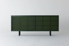 the sideboard is made out of dark green wood and has several compartments for storing items