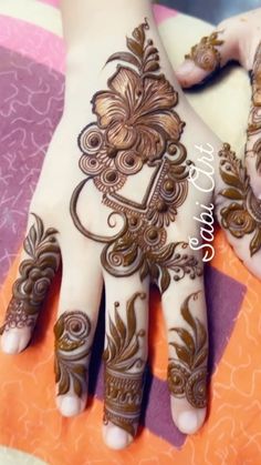 the hands are decorated with henna designs