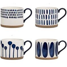 four blue and white coffee cups with spoons on them