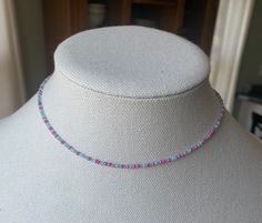 Dainty choker style necklace with pink and aqua seed beads. This is a true choker with a smaller fit, 15 inches around. Perfect for smaller necks or tweens/teens. Pink Tiny Beads Choker Necklace, Pink Choker With Round Tiny Beads, Pink Beaded Dainty Choker, Adjustable Pink Choker With Colorful Beads, Adjustable Pink Colorful Beaded Choker, Adjustable Pink Beaded Choker, Pink Choker With Tiny Beads For Summer, Summer Pink Choker With Tiny Beads, Adjustable Pink Beaded Chain Choker