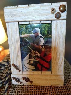 an old photo frame with two men fishing