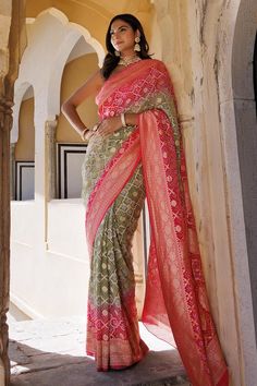 Pink, green saree with bandhani tie dye pattern, geometric woven motifs and zari on border. Comes with unstitched blouse piece.
Components: 2
Pattern: Woven
Type Of Work: Geometric, zari
Fabric: Dola Silk
Color: Pink,Green
Other Details: 
Handcrafted
Length:
Saree: 5.5 mtrs
Blouse: 1 mtr
Approx. product weight (in gms): 200
Disclaimer: Since these products are handcrafted and hand dyed, hence may have slight irregularities and dissimilarities each time it is crafted. This is a natural outcome of Green Bandhani Print Traditional Wear For Transitional Season, Green Bohemian Traditional Wear With Bandhani Print, Transitional Green Bandhani Traditional Wear, Bohemian Green Traditional Wear With Bandhani Print, Transitional Green Bandhani Print Dupatta, Green Traditional Wear With Bandhani Print, Festive Green Bandhani Print Traditional Wear, Green Bandhani Print Traditional Wear For Ceremonies, Green Traditional Blouse With Bandhani Print