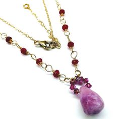 Beautifully handcrafted 14 kt gold-filled wire wrapped lavender and fuchsia gemstone necklace. Stand out on any occasion wearing this elegant gemstone crystal necklace. Length of the necklace is adjustable to 18-20 inches     14 Kt Gold Fill wire wrapped  interlocked sections  14 kt Gold Fill sparkly cable chain  14 kt Gold Fill Medium size lobster clasp closure  1 candy jade drop is 15x12 mm  14 ruby color chalcedony roundels 3x4mm  7 fuchsia Swarovski crystals 3mm  Adjustable length18-20 inche Puzzle Piece Necklace, Lavender Jade, Ruby Color, Necklace Stand, Gold Filled Necklace, Pearl Choker Necklace, Chic Jewelry, Turquoise Gemstone, Gold Filled Chain