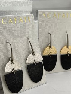 These textured earrings  are plated with 18 K gold and a silver alloy over brass. They are glossy because they're rack plated. This means that the pieces are hand hung so they receive the optimal amount of coverage.   The  black is a charcoal alloy plated over brass enhanced with black Patina. The following combinations are available: Silver Hook - Black and Silver Silver Hook - Gold and Silver   All metals used are lead safe. Modern Hammered Earrings For Everyday, Modern Hammered Linear Earrings For Gift, Modern Hammered Linear Earrings As Gift, Modern Adjustable Earrings For Pierced Ears, Modern Adjustable Earrings, Modern Silver Brass Earrings, Adjustable Modern Linear Earrings, Modern Silver Linear Earrings In Brass, Modern Silver Brass Linear Earrings