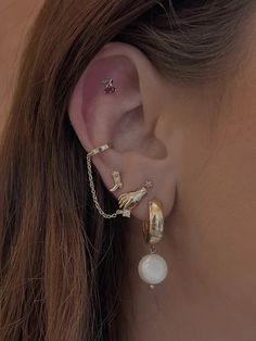 a close up of a person's ear with two different types of piercings