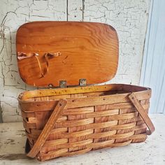 an old wooden box with a lid sitting on top of it's back legs