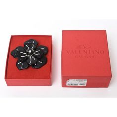 This is part of Chairish’s Costume Jewelry assortment.  This lovely and dramatic Italian Valentino hard black resin rhinestone flower pin or brooch makes a beautiful addition to any ensemble given day or evening. It is from 2000. Very well made as any authentic Valentino piece is. It has its original Valentino red box. it is 4" round. This will be stunning on any jacket, blouse or dress as it will make a statement. Can go for all seasons and even resort wear!  The camellia flower is a staple in Jacket Blouse, Giving Day, Valentino Red, Black Tears, Camellia Flower, Valentino Black, Black Resin, Rhinestone Flower, Modern Branding