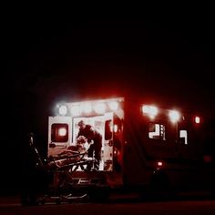 an ambulance with its lights on at night