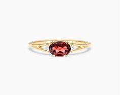 14K Yellow Gold Oval Garnet and Diamond Accent Birthstone Ring. The birthstone of January, Garnets are known for their captivating deep color. Garnets are said to bring love, luck, health, protection and friendship to those who wear it. This garnet ring with accent diamonds is the perfect piece for your special someone Oval Ruby Ring With Gemstone Accents In Yellow Gold, Oval Ruby Birthstone Ring With Gemstone, Oval Ruby Birthstone Ring Fine Jewelry, Oval Ruby Birthstone Ring, Oval Ruby Birthstone Ring In Fine Jewelry Style, Oval Ruby Ring With Gemstone Accents In 14k Gold, Oval Birthstone Promise Ring With Gemstone, Heirloom Garnet Oval Birthstone Ring, Oval Garnet Ring In Yellow Gold