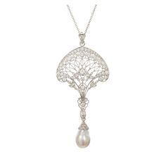 Edwardian Pearl and diamond open work pendant necklace. Platinum filigree pave set diamonds. Iridescent silvery South Sea semi-precious baroque pearl with rolling tints of both greenish blue and pink. The bail on the pearl opens. It can be removed from the pendant to wear either the pearl or the pendant without one another. Platinum chain. 1 Baroque South Sea pearl. Shape: 10.5mm x 17mm 64 round diamonds approx. total weight 1.90cts, F, VS Platinum Tested Platinum 20.3 grams Length of Chain: 16 Classic Silver Baroque Necklace, Exquisite White Filigree Necklace, Exquisite White Filigree Necklaces, Formal Diamond Filigree Necklace, Drop Pearl Pendant Jewelry For Evening, Elegant Filigree Jewelry In Diamond White, Luxury Baroque Pearl Necklace For Wedding, Luxury Silver Pear-shaped Diamond Necklace, Elegant White Gold Briolette Diamond Necklace