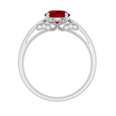 a ring with a red stone and two white diamonds on the side, set in 18k white gold