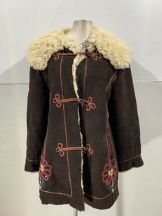 "Up for auction is a great Vintage Afghan Princess Coat. VINTAGE AFHGAN LEATHER JACKET APPROXIMATE MEASUREMENTS ARE NO SIZE LABEL LAID FLAT ACROSS THE CHEST FROM SIDE TO SIDE 21\" DOWN THE BACK, BOTTOM OF COLLAR TO HEM 33\" SHOULDER TO END CUFF 23\" SHOULDER TO SHOULDER 19\" TWO WAIST POCKETS YOU ARE BUYING A USED ITEM OF CLOTHING. YOUR OPINION MAY DIFFER TO OURS BUT WE DO OUR BEST TO BE HONEST. Please do not hesitate to email before purchasing  Condition : USed vintage condition, could use a cleaning but overall the leather is still very soft and the fur is greyed from the age. The hem may need some repairs and the stitching needs to be restitched near the pocket. sold as is. Has a bit of shedding in fur from age.  THANKS FOR LOOKING  All sales are final, thanks!!" 70’s Jacket, Retro Embroidered Winter Outerwear, Vintage Brown Embroidered Outerwear, Vintage Embroidered Winter Outerwear, Afghan Jacket, 70s Inspired Outfits, Princess Coat, Cute Coats, Clothes Pictures