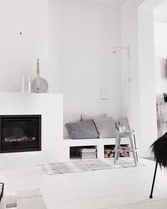 a living room with white walls and furniture