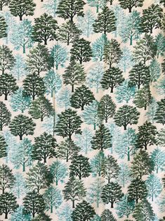 a blue and green tree print fabric with trees on the back in various sizes, shapes and colors