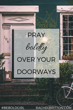 a bicycle parked in front of a green building with the words pray boldly over your doorways