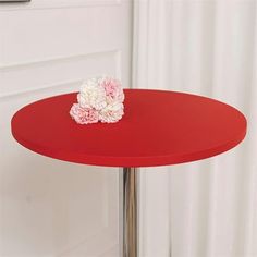 a red table with a flower on it