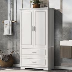 a bathroom with a white cabinet next to a towel rack and toilet paper dispenser