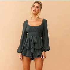 This Playsuit Features A Scooped Ruched Bust, Buffet Sleeves, A Snatched Waist With A Waist Tie And Two Tiered Flounce Shorts. This Playsuit Is Super Flirty And Cute And Can Be Dressed Up Or Down According To Your Desire. Size Guide: Au 8 / Us 4 Bust: 83cm/33in Waist: 68cm/27in Hip: 91cm/36in Cold Hand Wash Only. Green Long Sleeve Playsuit. Model Is A Standard Xs And Is Wearing Size Xs For This Style. True To Size. Fully Lined. Ruched Bust May Vary. Ribbon Waist Tie. Invisible Back Zip. 65% Poly Chic Long Sleeve Jumpsuits And Rompers For Holiday, Fitted Long Sleeve Jumpsuits And Rompers For Holiday, Fitted Long Sleeve Jumpsuits And Rompers With Ruffles, Fitted Jumpsuits And Rompers With Ruffles And Long Sleeves, Fitted Ruffled Jumpsuits And Rompers For Brunch, Fitted Ruffled Jumpsuit For Brunch, Fall Fitted Jumpsuits And Rompers With Ruffles, Fitted Green Jumpsuits And Rompers With Ruffles, Green Fitted Jumpsuit With Ruffles