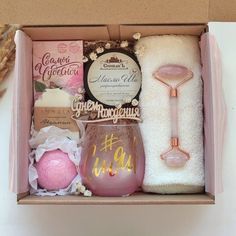 an open box with some items in it that are pink and gold on the inside