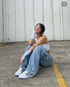 a woman sitting on the ground with her head up