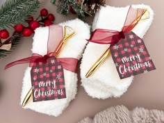 two christmas stocking holders with tags on them