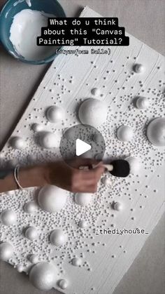 someone is painting balls on the paper with white paint and a black marker that says, what do u think about this canvas?