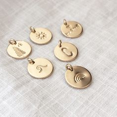 Everyday Medallion Jewelry With Charms, Minimalist Round Charms For Gifts, Minimalist Round Gift Charms, Brass Round Charm Necklace, Everyday Round Minimalist Charms, Minimalist Everyday Round Charms, Personalized Round Pendant Charms For Everyday, Everyday Symbolic Round Pendant Jewelry, Minimalist Personalized Round Charms