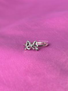 A stunning coquette style ring featuring a darling ribbon bow tie. - Water resistant - 925 sterling silver - Will not rust or tarnish - Select desired size at checkout Elegant Star-shaped Midi Rings As Gift, Adjustable Silver Butterfly Ring Minimalist Style, Adjustable Silver Midi Rings As Gifts, Minimalist Adjustable Silver Butterfly Ring, Celestial Silver Midi Rings For Anniversary, Celestial Silver Midi Promise Rings, Adjustable White Gold Sterling Silver Butterfly Ring, Adjustable Star-shaped Midi Rings As Gift, Dainty Silver Midi Rings For Gift