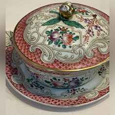 an ornately decorated tea pot and saucer