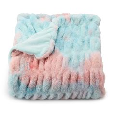 a blanket with pink and blue colors is folded up on a white surface, it's made out of fleece