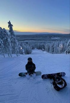 two snowboarders sitting in the snow with their boards