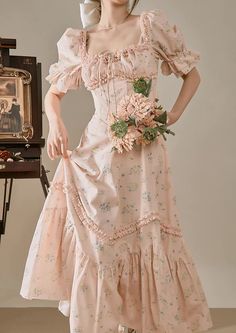 Feel like a princess in this sweet ditsy floral dress with a square neckline, short puff sleeves, ruffle details, basque waistline and mermaid flared midaxi skirt. Waist is enforced with fishbone boning and cinches with a self-tie waist strap. Concealed back zipper. S: 31.5" chest, 26" waist, 48" lengthM: 33" chest, 27.5" waist, 48" lengthL: 34.5" chest, 29" waist, 48" length Princess Outfits Casual, House Wife Dress, Wife Dress, Cultural Clothes, Housewife Dress, Floral Dress Pink, Midaxi Skirt, Princess Fashion, Ditsy Floral Dress