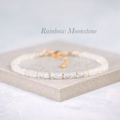 Beautiful natural Rainbow Moonstone gemstones are interspersed with your choice of tiny Gold Vermeil or Sterling Silver beads in this elegant bracelet. The Rainbow Moonstone beads are entirely natural and feature plenty of the mesmerising adularescence (blue flash) for which this gemstone is so loved. - Completely natural genuine gemstones measure approx. 3.5-4.5mm - Bracelet extends from 6.5-8 inches (custom sizes available on request) - Packaged in a gift box with gemstone information card ready for gifting or treating yourself - Choose from Gold Fill or 925 Sterling Silver The Rainbow Moonstone beads feature mesmerising blue flashes, and are a faceted rondelle shape with excellent sparkle. A birthstone for the month of June, Rainbow Moonstone is a magical looking stone, with internal gl Elegant Moonstone Gemstone Beaded Bracelets, Delicate White Bracelets With Natural Stones, Delicate White Bracelet With Natural Stones, Elegant Crystal Bracelet With Gemstone Beads And Moonstone, Elegant Moonstone Crystal Bracelet With Gemstone Beads, Moonstone Gemstone Beaded Bracelet As Gift, Minimalist Moonstone Bracelet With Round Beads, Minimalist Moonstone Bracelets With Round Beads, Adjustable Elegant Moonstone Beaded Bracelets