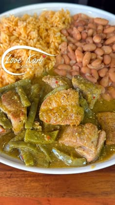 a white plate topped with beans, rice and meat