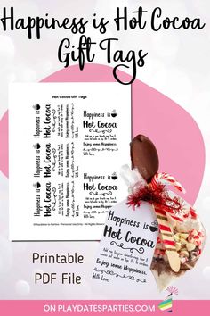 a candy bar with the words happiness is hot cocoa gift tags in front of it