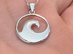 ".925 Sterling Silver Unisex High-polished Hawaiian Beach Ocean Wave Nalu Necklace. FREE Sterling Silver Italian Box Chain included In your choice of length. The size is smaller at 15MM, just above 1/2\". The Bail is 4MM. Handcrafted with attention to detail, the highly-reflective Sterling finish is both stunning and durable. This simple but substantial and unique Nalu design is a bestseller in our Hawaii stores. --Wave Jewelry was worn by ancient Hawaiians to give energy, courage, beauty and gr Sterling Silver Jewelry With Shiny Finish And Oval Shape, Oval Sterling Silver Jewelry With Shiny Finish, Silver Necklaces With Shiny Finish For Gifts, Silver Necklace With Shiny Finish For Gift, Oval Silver Jewelry With Shiny Finish, Sterling Silver Jewelry With Shiny Finish As A Gift, Symbolic White Round Jewelry, White Polished Finish Round Pendant Jewelry, White Symbolic Jewelry With Polished Finish