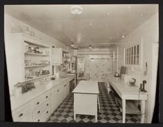 an old black and white photo of a kitchen with checkered flooring on the walls