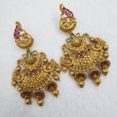 "These Jhumka Earrings set has an excellent finish and gives out an exquisite sense of style. If you are looking for an amazing Fashion Jewelry set for special occasions such as Anniversary, engagements, Party, Wedding or for gifting, then your search ends here. Handmade Indian Temple Jewelry, best to wear it for traditional ceremonies or Indian weddings. This bridal jewelry has ethnic finish. It has Cubic Zircon stones with ruby and emeralds. It is a Bollywood style one gram jewelry. There are Traditional Jeweled Dangle Danglers, Jeweled Drop Earrings For Festivals, Jeweled Drop Danglers For Festivals, Festive Jeweled Chandbali Earrings, Peacock Design Earrings For Festivals, Elegant Peacock Design Chandbalis For Festivals, Ornate Jeweled Earrings For Festive Occasions, Hand Set Chandbali Earrings For Ceremonial Occasions, Hand Set Chandbali Earrings For Ceremonial