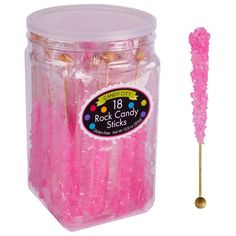 pink rock candy sticks in a plastic container