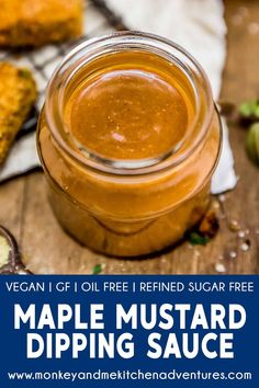 maple mustard dipping sauce in a glass jar on a wooden table with other ingredients around it