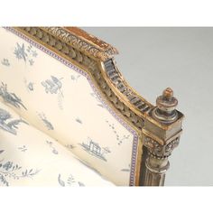 an ornately decorated chair with blue and white fabric