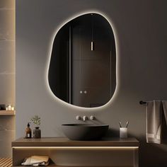 a bathroom with a sink, mirror and lights on the wall above it's counter