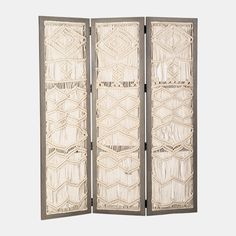 three - paneled screen with woven panels in white and grey tones, on a gray background